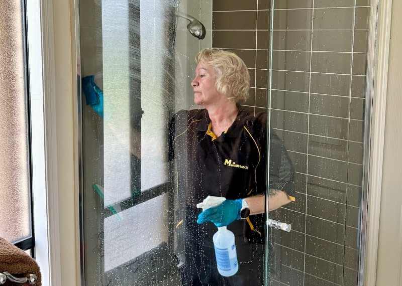Maid2Match professional house cleaner cleaning glass shower screen