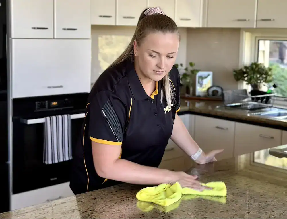 Maid2Match domestic cleaner wiping the kitchen benchtop