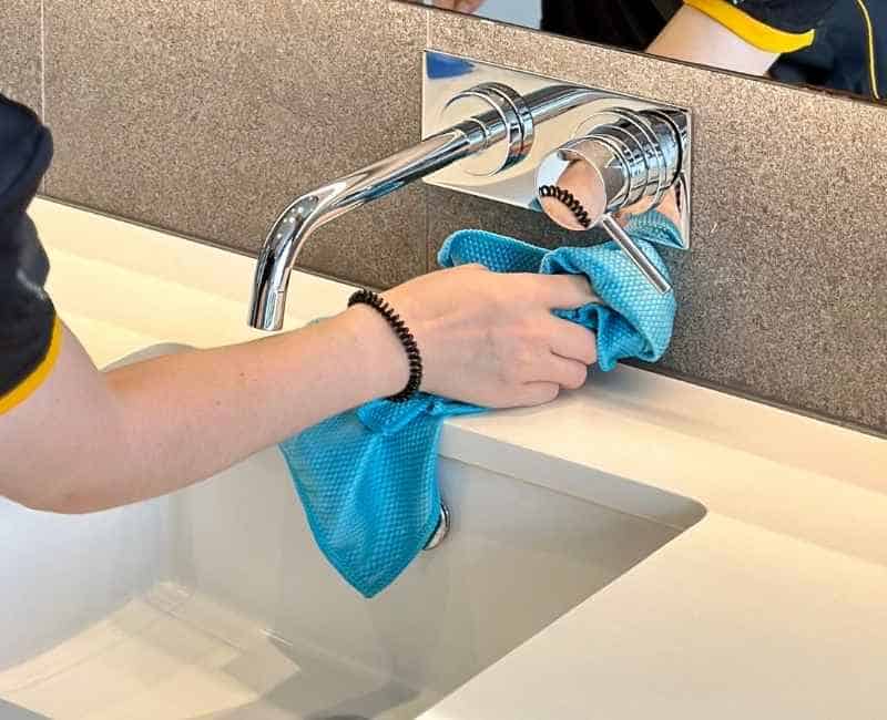 Maid2Match professional house cleaner cleaning around bathroom sink