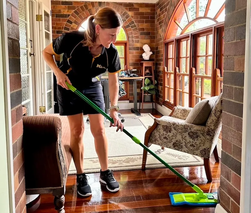 Maid2Match expert local cleaner using flat mop to clean wooden floor