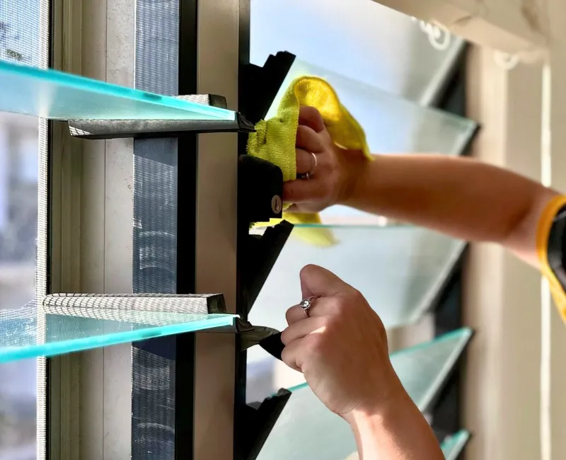 Close-up of domestic house cleaner cleaning windows