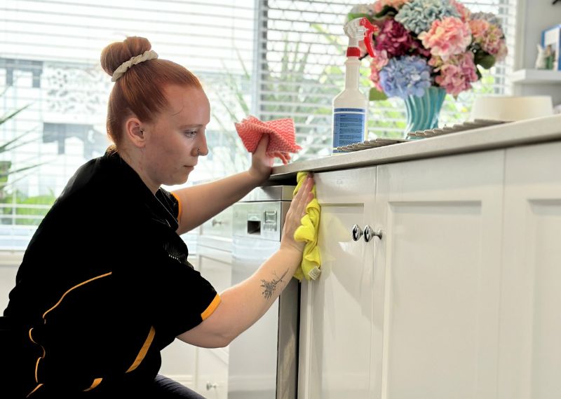 permanently-employed-cleaner-cleaning-cabinets Maid2Match permanent employee cleaner cleaning cabinets